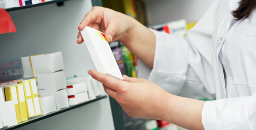 Pharmacist holding a box of tablets